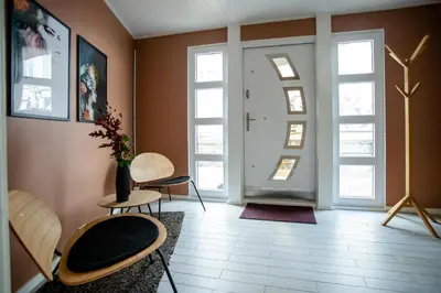 a room with two chairs and a door with windows at Floating Villa Bergen in Bergen