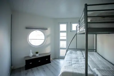 a bedroom with a bunk bed and a window at Floating Villa Bergen in Bergen