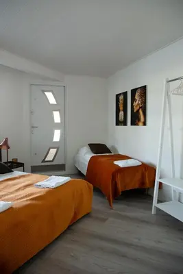 a bedroom with two beds and a window at Floating Villa Bergen in Bergen