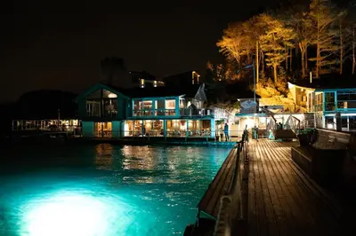 a house on a dock with the water at night at Floating Villa Bergen in Bergen