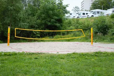a volleyball court with a net in the sand at Volsdalen Camping in Ålesund
