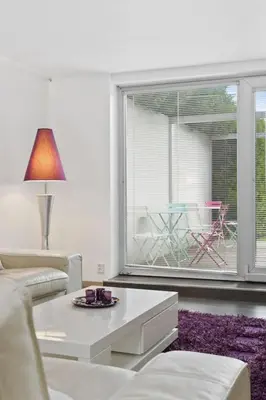 a living room with a couch and a table at Peak Apartments in Vossevangen