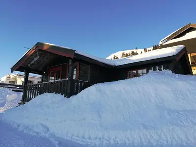 a pile of snow in front of a house at Sulseter Fjellstugu in Vinstra