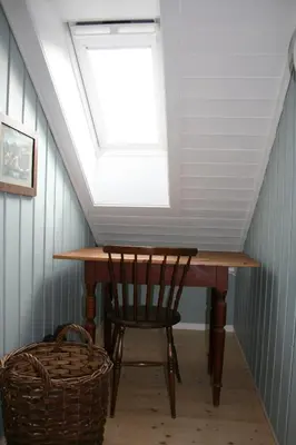 a skylight in a room with a table and a chair at Klara House in Isfjorden