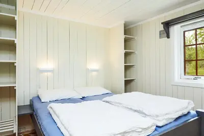 a bedroom with a bed with two pillows on it at Brennabu in Ron