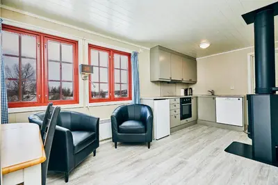 a kitchen with two chairs and a stove at Brennabu in Ron