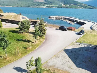 a car parked on a road next to a body of water at 10 person holiday home in EIDSVÅG-By Traum in Rød
