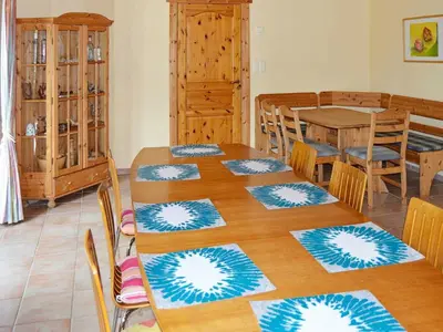 a room with a table with chairs and a dining room at 10 person holiday home in EIDSVÅG-By Traum in Rød