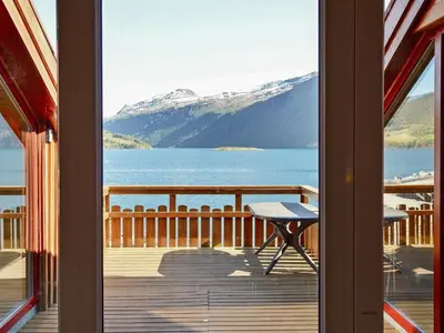 a view of a lake from a balcony with a table at 6 person holiday home in EIDSVÅG-By Traum in Rød