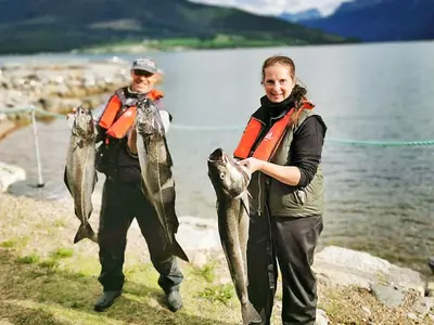 a man and a woman holding a bunch of fish at 6 person holiday home in EIDSVÅG-By Traum in Rød