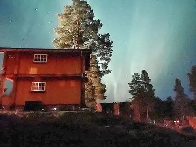 a red house with a tree in front of it at 5 person holiday home in Ringebu-By Traum in Ringebu