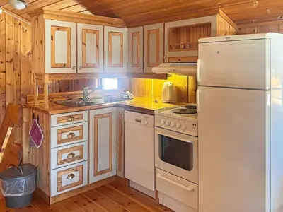 a kitchen with white appliances and wooden cabinets at 5 person holiday home in Ringebu-By Traum in Ringebu
