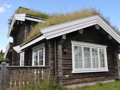 an old log cabin with grass on the roof at 8 person holiday home in Fåvang-By Traum in Tromsnes