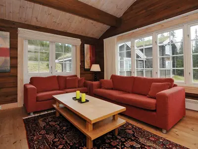a living room with two red couches and a coffee table at 8 person holiday home in Fåvang-By Traum in Tromsnes