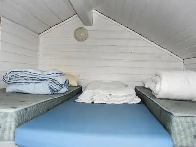a room with two pillows on two beds in a room at 5 person holiday home in Selje-By Traum in Selje