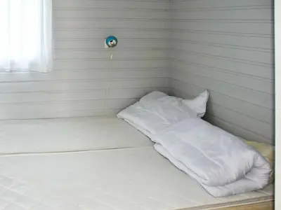 a bed with white pillows on it in a room at 5 person holiday home in Selje-By Traum in Selje