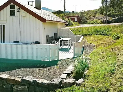 a house with a deck and a table and chairs at 4 person holiday home in VEVANG-By Traum in Vevang