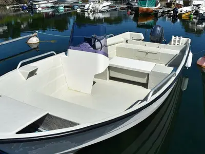 a white boat is docked in the water at 4 person holiday home in VEVANG-By Traum in Vevang