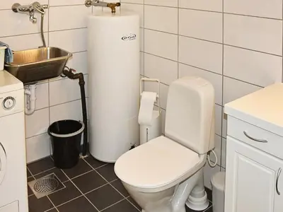 a bathroom with a white toilet and a sink at 6 person holiday home in Leirvik i Sogn-By Traum in Bø
