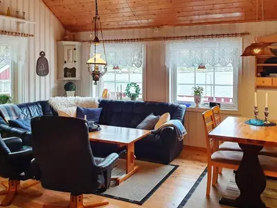 a living room with a blue couch and a table at 8 person holiday home in Sundlandet in Snildal