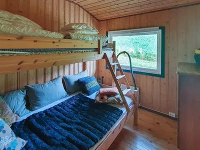 a bedroom with a bunk bed and a ladder at 8 person holiday home in Sundlandet in Snildal