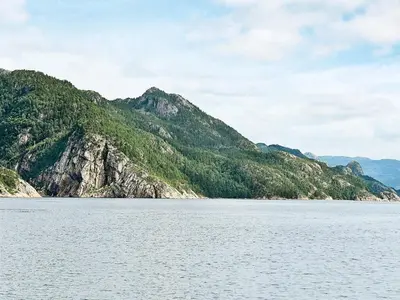 a large body of water with mountains in the background at 8 person holiday home in Sundlandet in Snildal