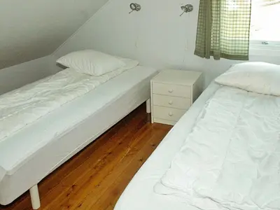 two beds in a small room with aermottermottermott at 8 person holiday home in Sørbøvåg in Sørbø
