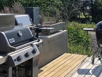 a grill and smoker on a wooden deck at 10 person holiday home in Tornes I Romsdal in Tornes