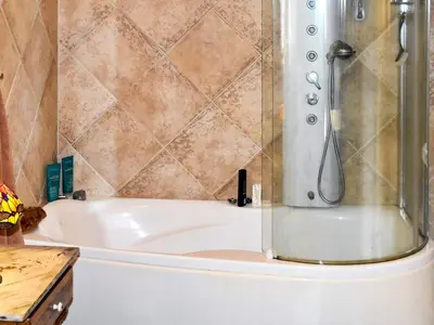 a bathroom with a bath tub with a shower at 10 person holiday home in Tornes I Romsdal in Tornes