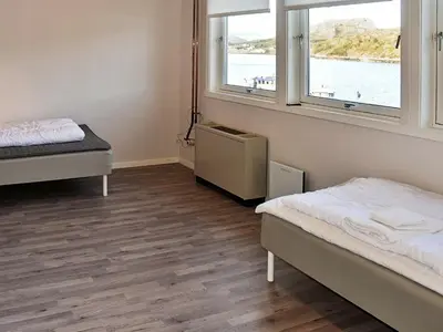a room with two beds and two windows at 12 person holiday home in Oksvoll in Oksvoll