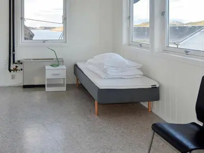 a hospital bed in a room with two windows at 8 person holiday home in Oksvoll in Oksvoll