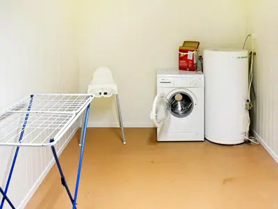a laundry room with a washing machine and a washer at 8 person holiday home in Oksvoll in Oksvoll