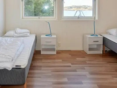 a room with two beds and two night stands at 8 person holiday home in Oksvoll in Oksvoll