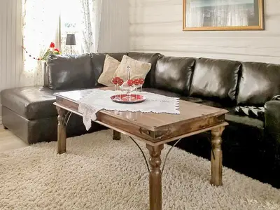 a living room with a table with two glasses of wine at 8 person holiday home in averøy in Henda