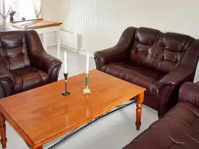 a living room with two leather couches and a coffee table at 8 person holiday home in averøy in Henda