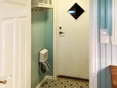 a bathroom with a door with a toilet in it at 8 person holiday home in averøy in Henda
