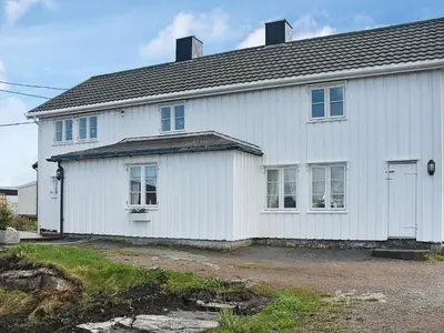 a white house with a lot of windows at 8 person holiday home in averøy in Henda