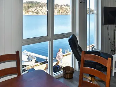 a dining room with a view of the water at 8 person holiday home in Urangsvåg in Ervik