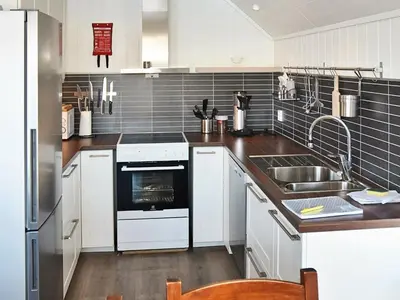 a kitchen with a sink and a stove at 8 person holiday home in Urangsvåg in Ervik