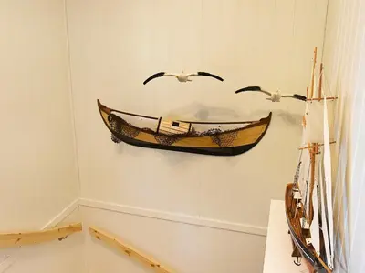 a museum exhibit with a boat on the wall at 8 person holiday home in Urangsvåg in Ervik