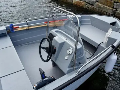 a boat with a steering wheel on the water at 8 person holiday home in Urangsvåg in Ervik