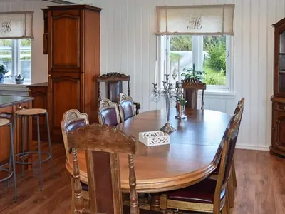 a dining room with a wooden table and chairs at 10 person holiday home in Folkestad in Folkestad