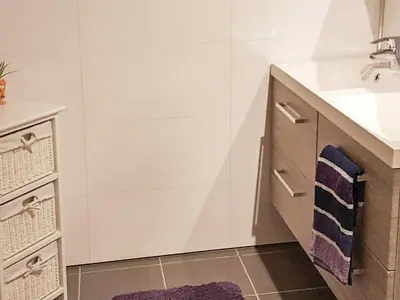 a bathroom with a sink and a vanity with towels at 10 person holiday home in Folkestad in Folkestad