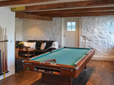 a pool table in a living room with a couch at 10 person holiday home in Folkestad in Folkestad