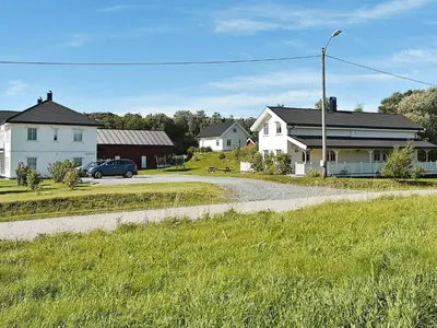 a street with houses and a car on a road at 8 person holiday home in Oksvoll in Oksvoll