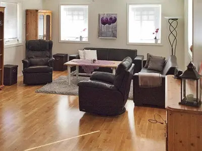 a living room with couches and a table and chairs at 8 person holiday home in Oksvoll in Oksvoll