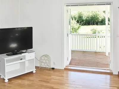 a living room with a flat screen tv on a white cabinet at 8 person holiday home in Oksvoll in Oksvoll