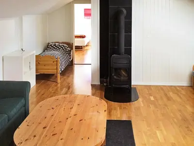 a living room with a couch and a wood stove at 8 person holiday home in Oksvoll in Oksvoll