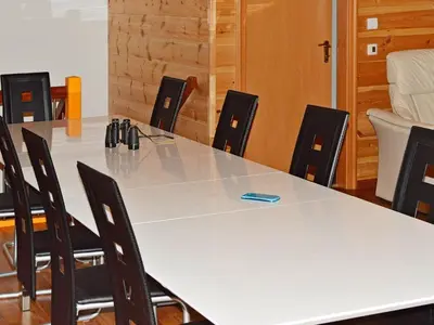 a conference room with a large white table and chairs at 10 person holiday home in EIDSVÅG in Rød