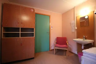a bathroom with a green door and a sink at Åndalsnes Hostel in Åndalsnes